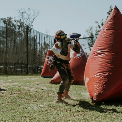 Man Readjusting His Position During a Game of Paintball